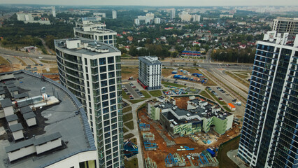 Fototapeta premium Construction site of a new city block. Construction of multi-storey buildings. Overcast weather. Aerial photography.