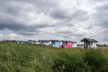 Fototapeta na wymiar Pastel-colored beach huts at Skanor beach, Scania county, south of Sweden. 