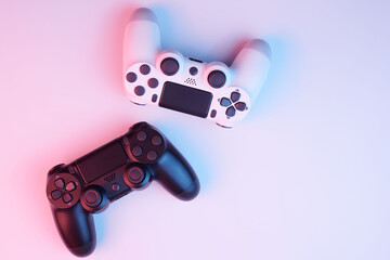 Two video game controllers, joysticks for game console isolated on white background. Gamer controlling devices close-up