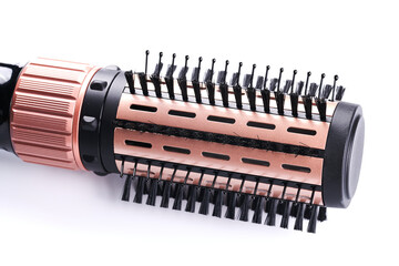 Electrical round brush hair dryer. Thermal and ceramic coating hair styler rotating brush, hairdressers tool closeup isolated on white background