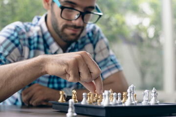 Man developing chess strategy, playing board game.