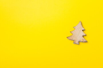 Wooden Christmas tree on color background, top view