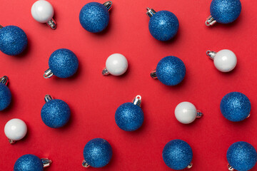 Christmas balls on color background, top view