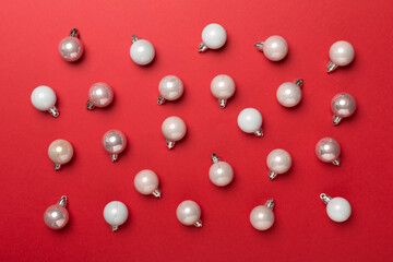 Christmas balls on color background, top view