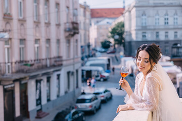 Fototapeta premium morning of the bride. A woman enjoys the view from the balcony o