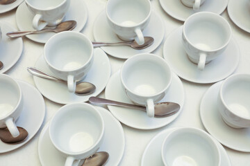 White tea cups with spoons