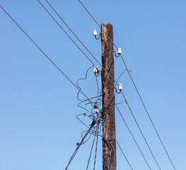 Old wooden electric pole against the sky.