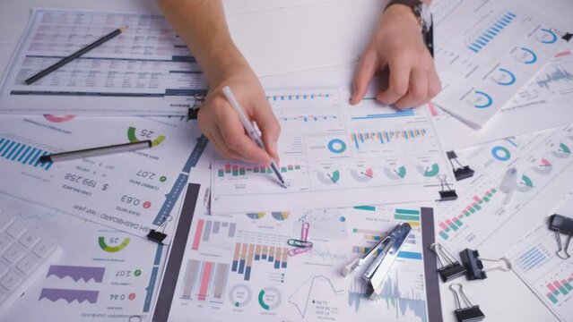 Accountant checks the analytical report on the stock market