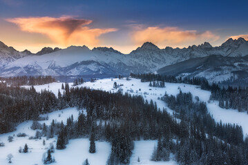 Tatra Mountains, winter, snow, frost. Panorama of the winter Tatra Mountains and peaks at sunrise,...