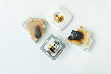 Electrical short circuit. Failure caused by burning wire and rosettes socket plug in house.