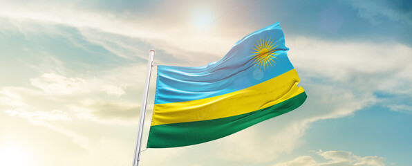 Rwanda national flag cloth fabric waving on the sky - Image