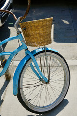 Fototapeta na wymiar vintage bicycle with straw basket parked on sidewalk