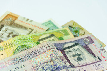 Obraz na płótnie Canvas Collection of Saudi Arabia riyal banknotes on a white background. Selective focus.
