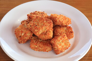 simple lunch, fried potatoes with cheese, on a white plate