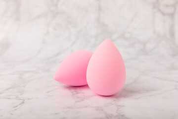 Beauty blender on a marble background.Sponge for makeup cosmetics. Makeup products. Beauty concept. Place for text. Space for copy. Flat lay