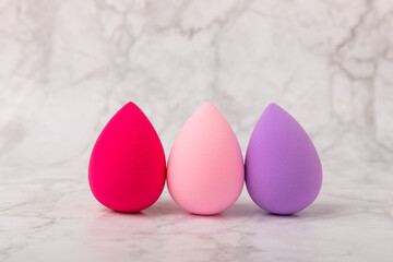 Beauty blender on a marble background.Sponge for makeup cosmetics. Makeup products. Beauty concept. Place for text. Space for copy. Flat lay