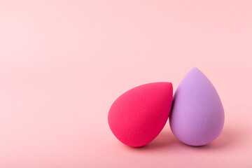 Beauty blender on a pink background.Bright sponges for make-up cosmetics. Makeup products. Beauty concept. Place for text. Space for copy. Flat lay