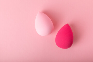 Beauty blender on a pink background.Bright sponges for make-up cosmetics. Makeup products. Beauty concept. Place for text. Space for copy. Flat lay