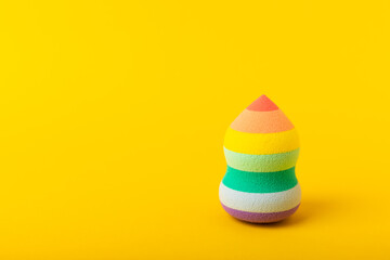 Beauty blender on a yellow background.Sponge for makeup cosmetics. Makeup products. Beauty concept. Place for text. Space for copy. Flat lay