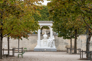 Paris, France - 09 16 2022: Tuileries garden. Marble sculputre of two men and a woman looking at the bust of Waldeck Rousseau