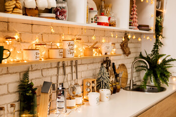 Kitchen interior decorated with Christmas garlands and Christmas trees