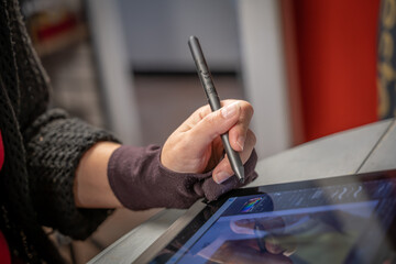 dessinatrice en train de réaliser une bande dessinée sur une tablette tactile