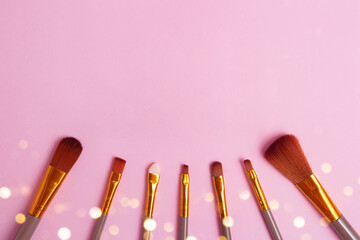 Photography from above of set of makeup brushes,negative space for text or design.
