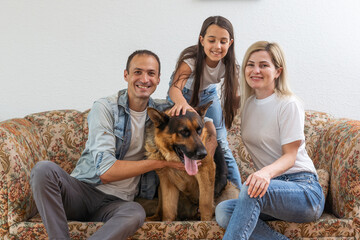 Portrait of happy family with a dog having fun together at home