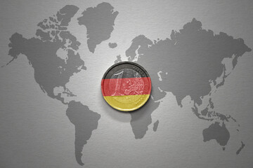 euro coin with national flag of germany on the gray world map background.3d illustration.