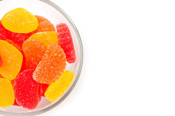 Jelly sweets citrus mix unglazed lying in a round glass bowl.