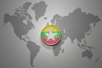 euro coin with national flag of myanmar on the gray world map background.3d illustration.
