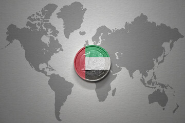 euro coin with national flag of united arab emirates on the gray world map background.3d...