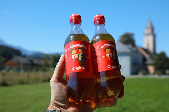 CARINTHIA, AUSTRIA - AUGUST 9, 2022: Almdudler carbonated soft drink in plastic bottles. The sweetened drink with herbal extracts is one of most recognized soft drinks in Austria.