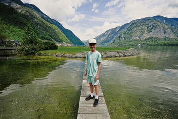 Boy stand on small wooden bridge at Hallstatt, Austria.