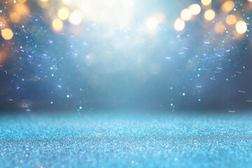 background of abstract glitter lights. gold, blue and silver. de focused