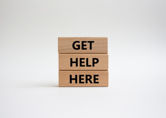 Get help here symbol. Wooden blocks with words Get help here. Beautiful white background. Business...