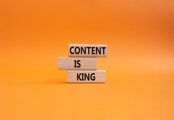 Content is king symbol. Concept words Content is king on wooden blocks. Beautiful orange background. Business and Content is king concept. Copy space.