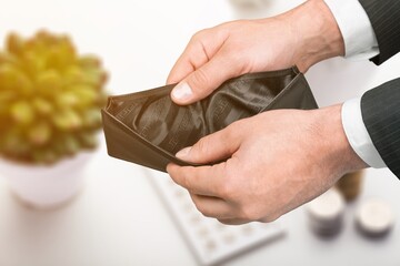 Stressed person with open wallet without money