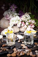 Obraz na płótnie Canvas Aromatherapy, spa, beauty treatment and wellness background with massage stone, flowers, burning candles... spa concept