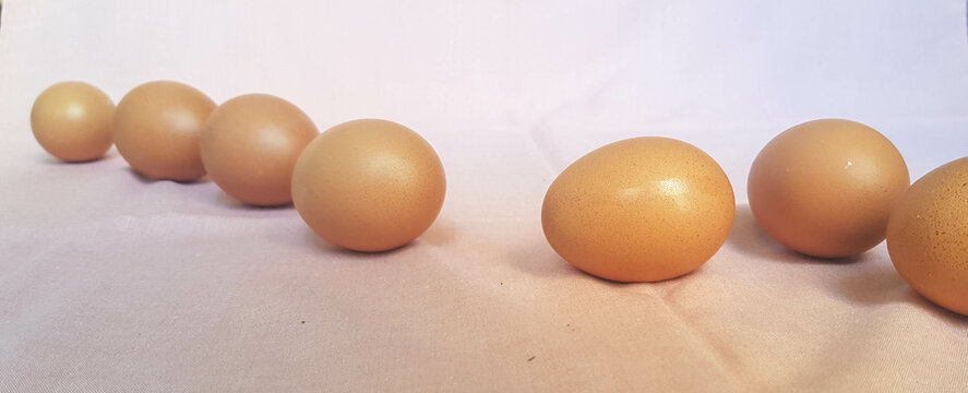 Some eggs are laid on a pink cloth.