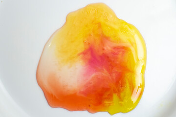 Melted multicolored jelly bears, in white background.