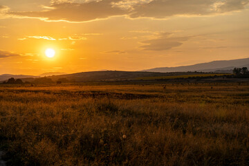 Golden sunset over the fields around the dam