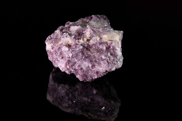 A fragment of the mineral lepidolite with a rough crystalline surface of a pinkish color