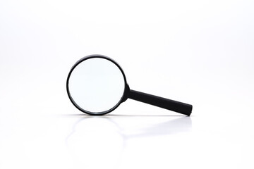 Loupe or magnifying glass on white. Shallow depth of field