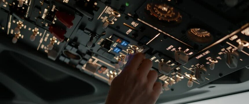 CU Commercial aircraft pilots adjusting flight parameters of the plane during the flight at high altitude. View from inside the cabin. Real aircraft, daytime shot