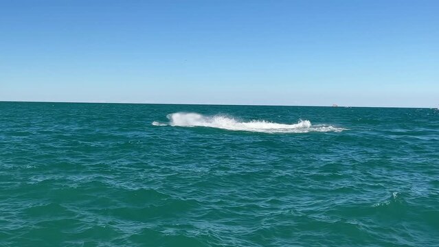 Quick turns on a jet ski on Lake Michigan. A tourist on a jet ski