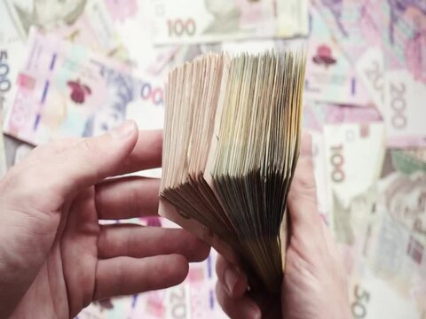 Account of Ukrainian paper banknotes of different denominations in the hands of a person