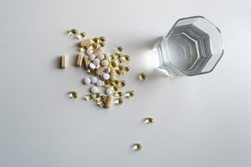 Gelatin capsules and white tablets of vitamin D3 on a white background
