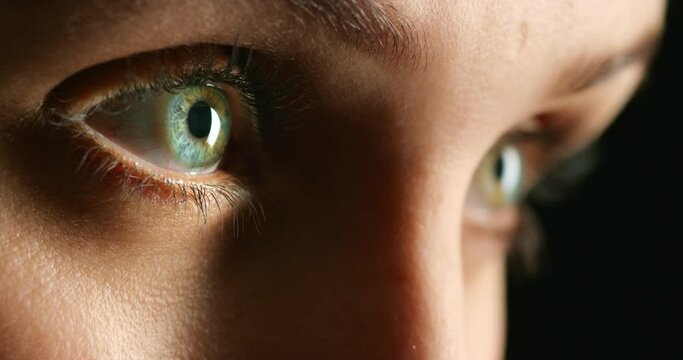 Eye, vision and woman zoom of blue and green eyes against a dark background. Macro view of Heterochromia, awareness and advertising of different, real people, optometry care or alternative beauty