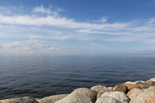 Öresund strait on a calm summer day with clear blue sky seen from rocky coast